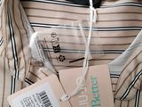 the shirt has a tag on it and a tag attached to it