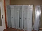 several lockers are lined up in a room with a door open
