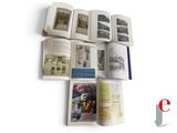 several open books on a white surface with pictures of people