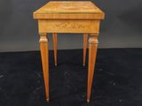 a small wooden table with two legs and a drawer on top