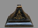 a black and gold clock sitting on top of a table