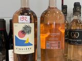 several bottles of wine are lined up on a counter