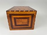 an old wooden box with a decorative design on the inside