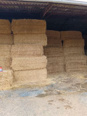 hay bales stacked up in a storage area in a barn