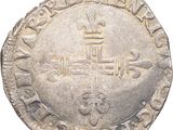a close up of a silver coin with a crown on it