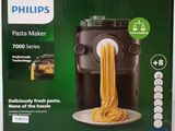 philips pasta maker with a plate of pasta and a bowl of noodles