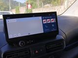 a tablet on the dashboard of a car with a view of a parking lot