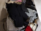 a pile of clothes in a white bag on the floor
