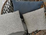 four pillows on a chair in a room