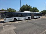 a white bus that is parked on the side of the road