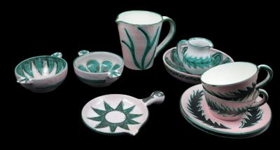 a tea set with a cup and saucer on a black background