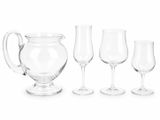 four wine glasses and a pitcher next to each other