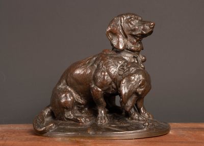 a bronze statue of a dog and a cat on a table