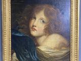 portrait of a young girl in a blue dress by a gold frame