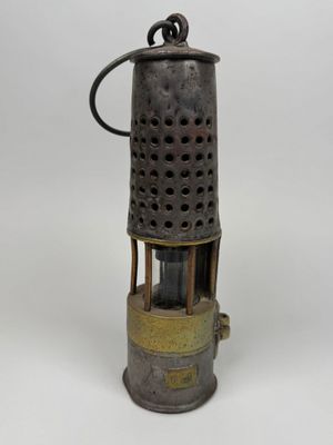 an old fashioned metal oil burner on a white background