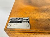 a label on the top of a wooden desk