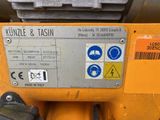 a close up of a yellow machine with a sticker on it