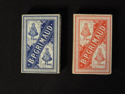 two playing cards sitting next to each other on a black surface