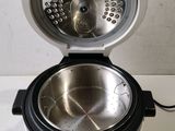 a silver and black rice cooker on a white counter