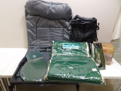 many bags of luggage sitting on a table next to a chair