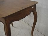 a small wooden table with a drawer on it