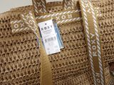a woven bag with a price tag on it