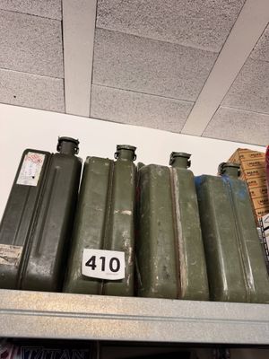 a shelf that has a lot of green containers on top of it