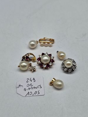 a close up of a bunch of jewelry on a white surface