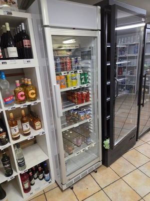 many bottles of alcohol on the shelves in the store