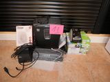 an image of a laptop and other electronics on the floor