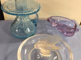 a glass bowl and a glass plate on a table