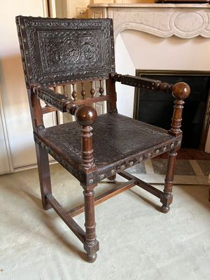 a wooden chair that is sitting in front of a fire place