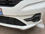 a close up of a white car with a license plate on it