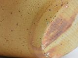 a close up of a vase on a white surface