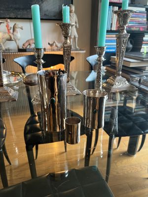 a glass table with candles on it in the middle of a room