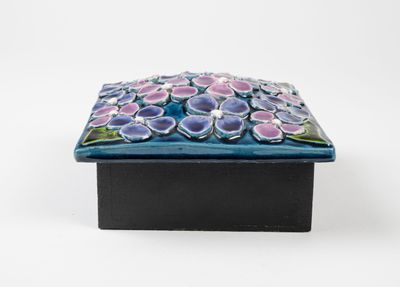 a close up of a small box with flowers on it