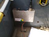 a metal box with wires attached to it in a room