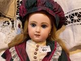 a doll that has a tag on it ' s neck