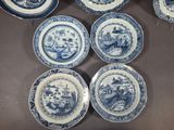 six blue and white plates with a picture of a man and a woman on them