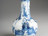 a blue and white vase sitting on a table