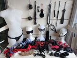 several mannequins are lined up on a table in front of a white wall