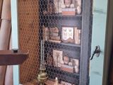 a small cabinet with a clock inside of it