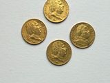 three gold coins with a picture of a man and a woman on them