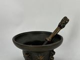 a black mortar with a wooden pestula in it on a white background