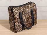 a leopard print bag sitting on top of a wooden table