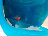 a blue and white container with a red light inside of it