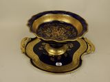 a blue and gold plate with a gold bowl on it
