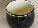 a black and white bowl sitting on a table