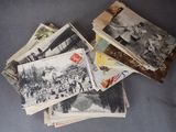 many old postcards on a table with a black and white photo