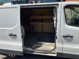 a white van that has its door open and is parked in a parking lot